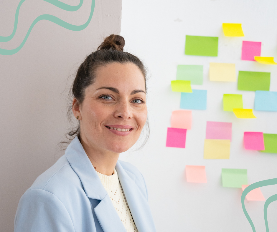 female med spa marketing expert staring at camera smiling in front of wall covered in sticky notes of all different colors
