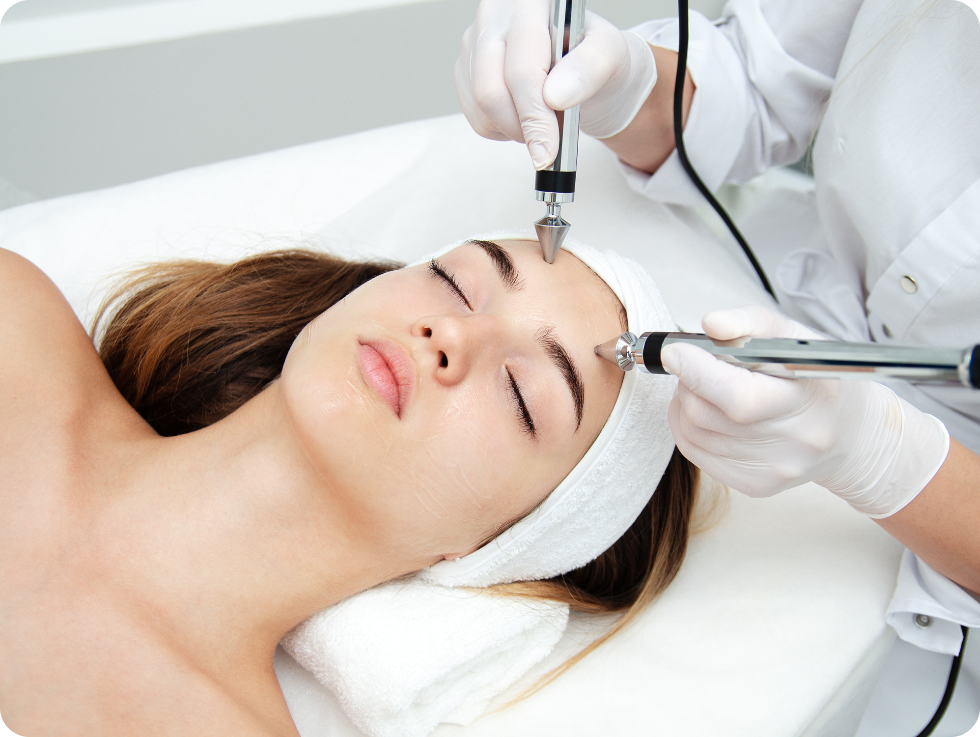 woman patient receiving relaxing treatment from esthetician